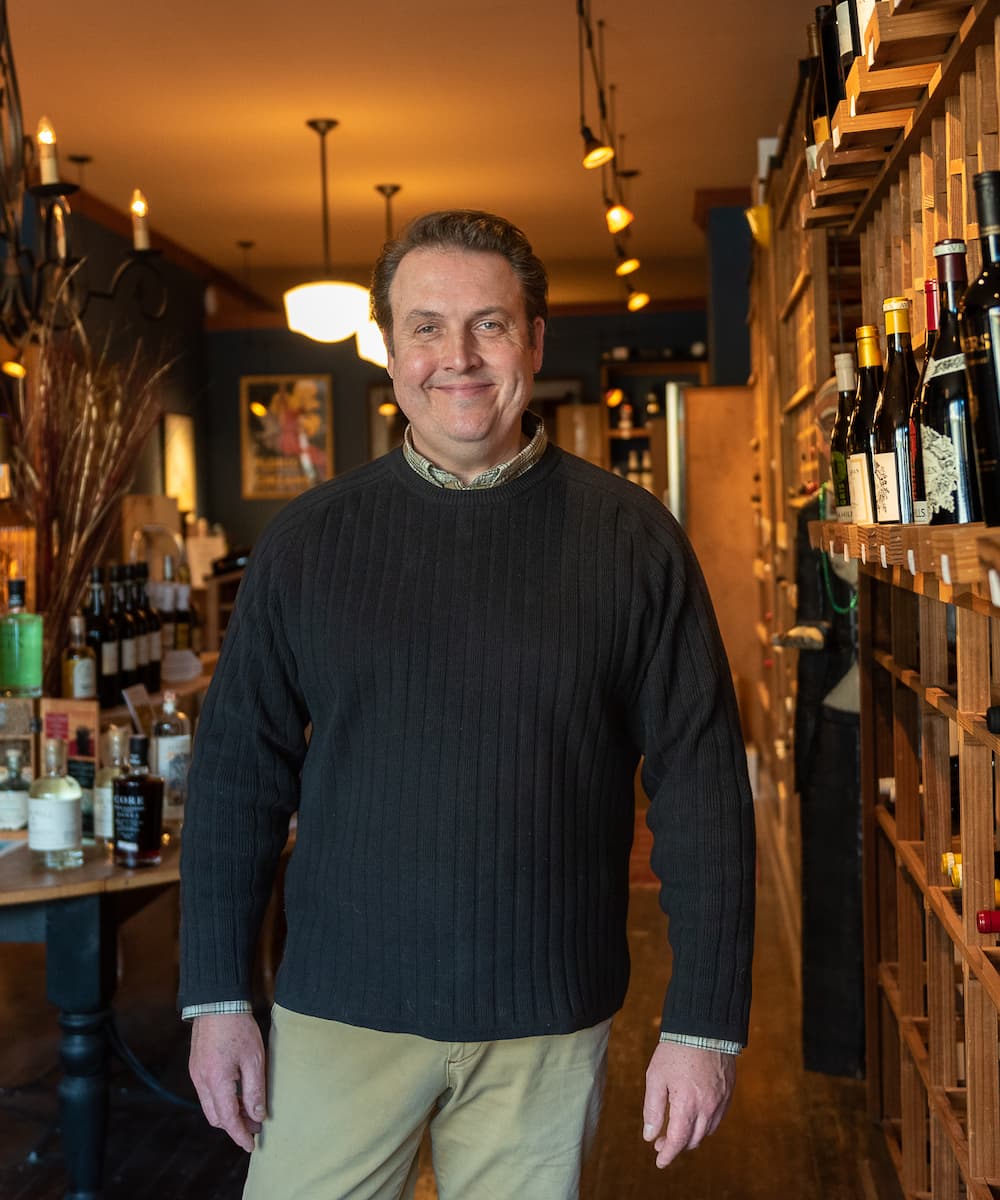 Chris, head consultant at Casa Bacchus, standing in a wine cellar